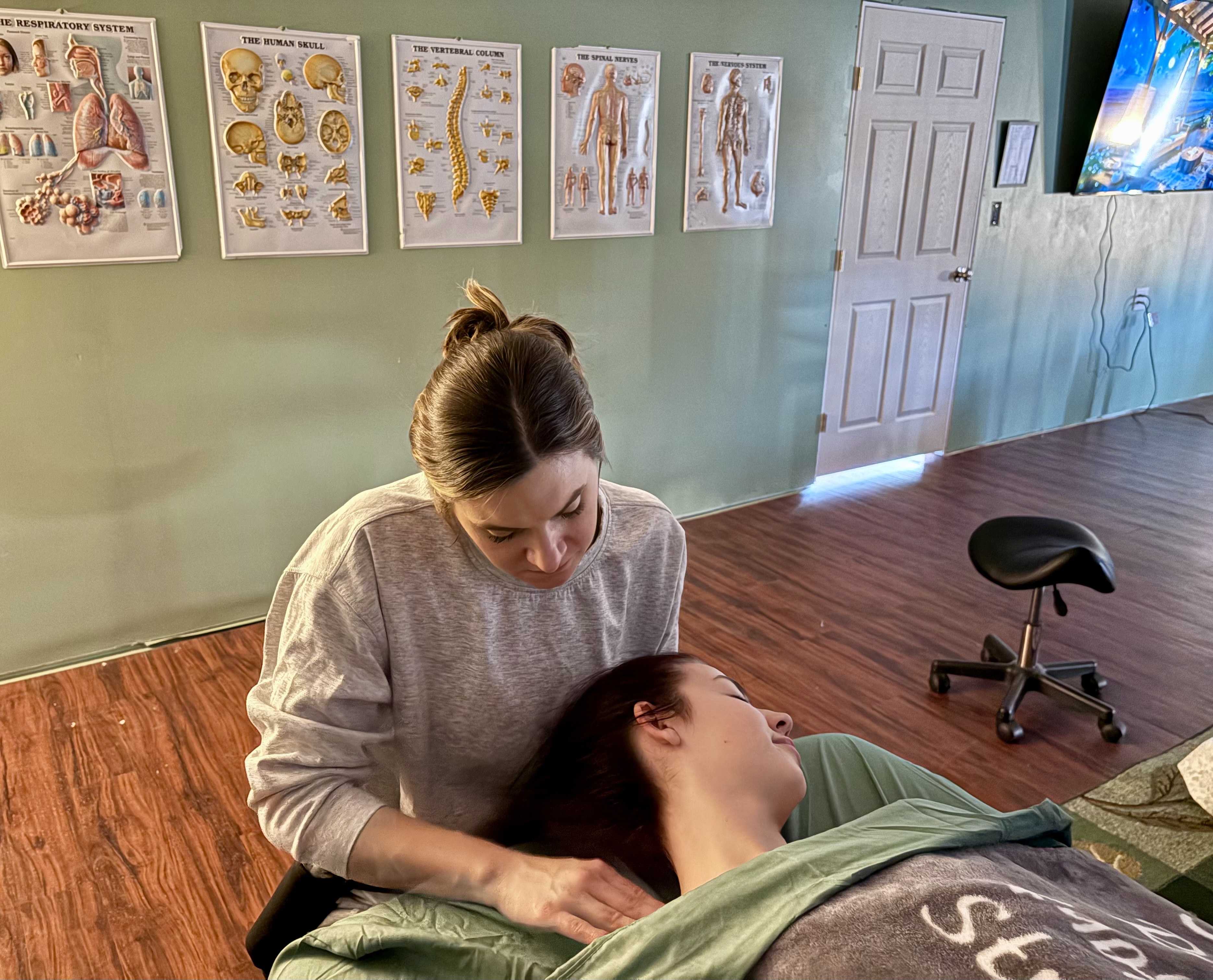Student working on a client's neck